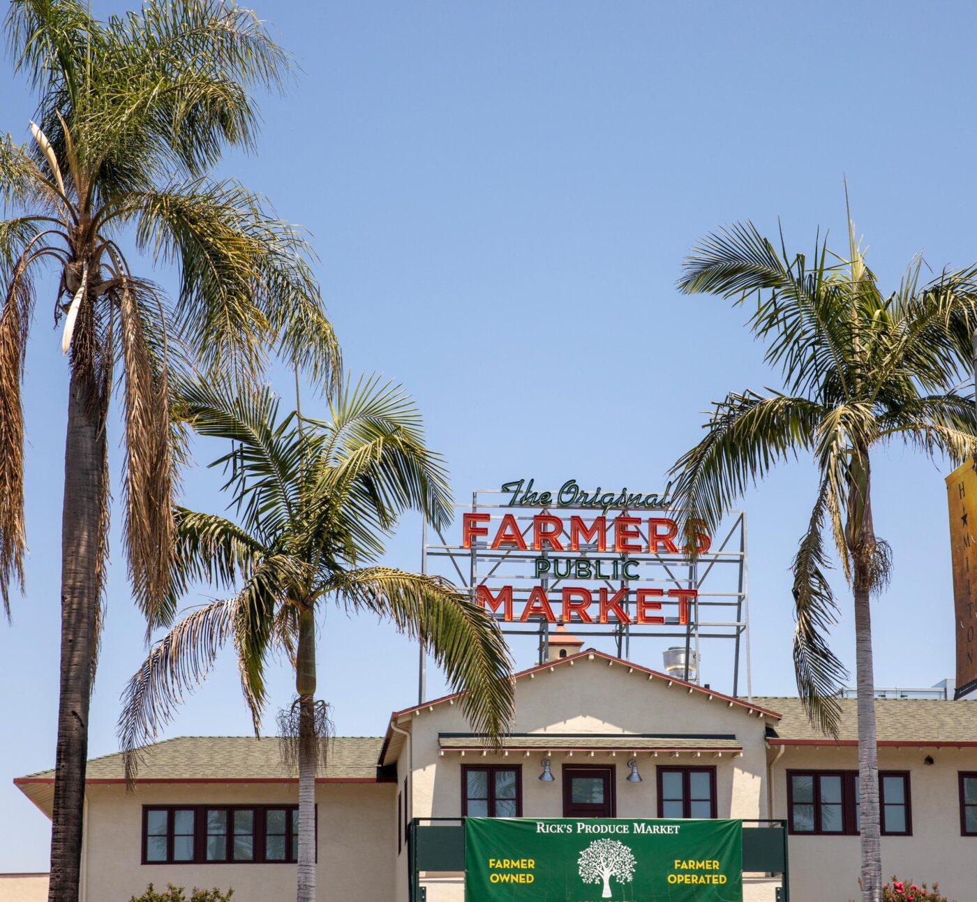 palm trees and farmers market sign
